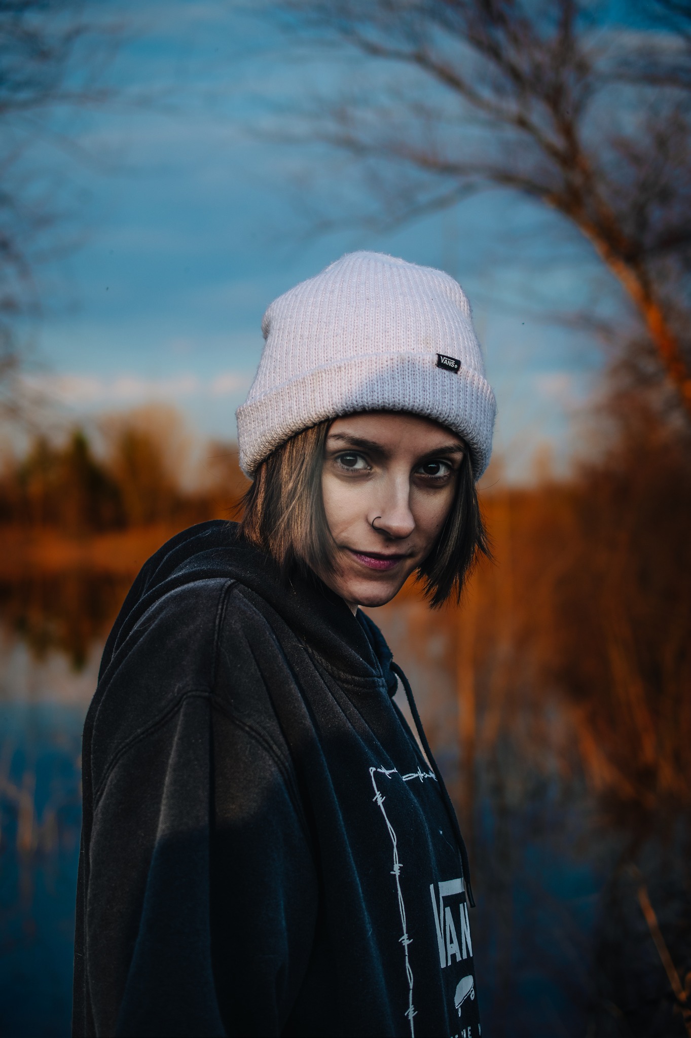 A portrait of a woman by a lake.