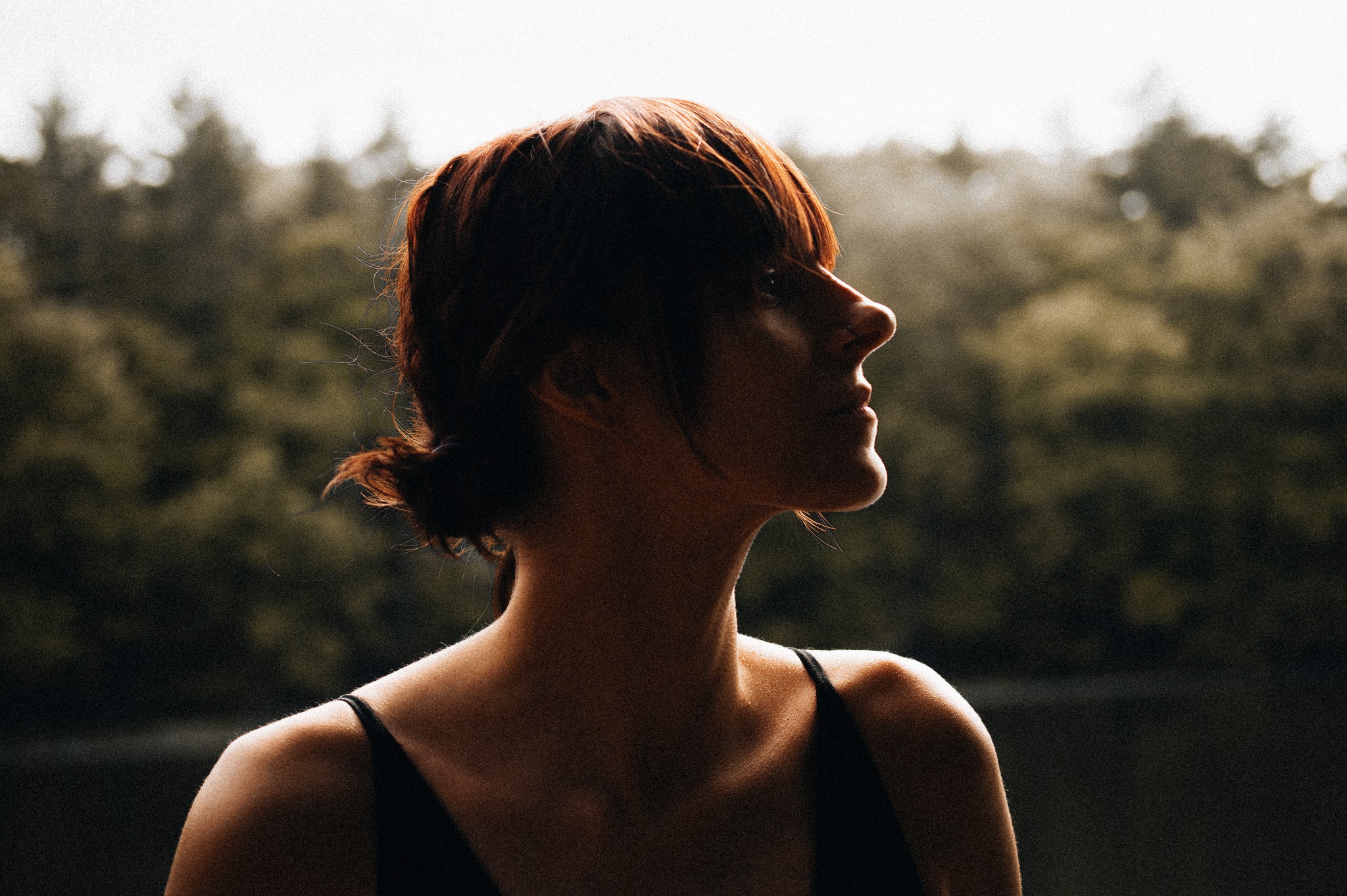 A portrait of a woman by a lake.