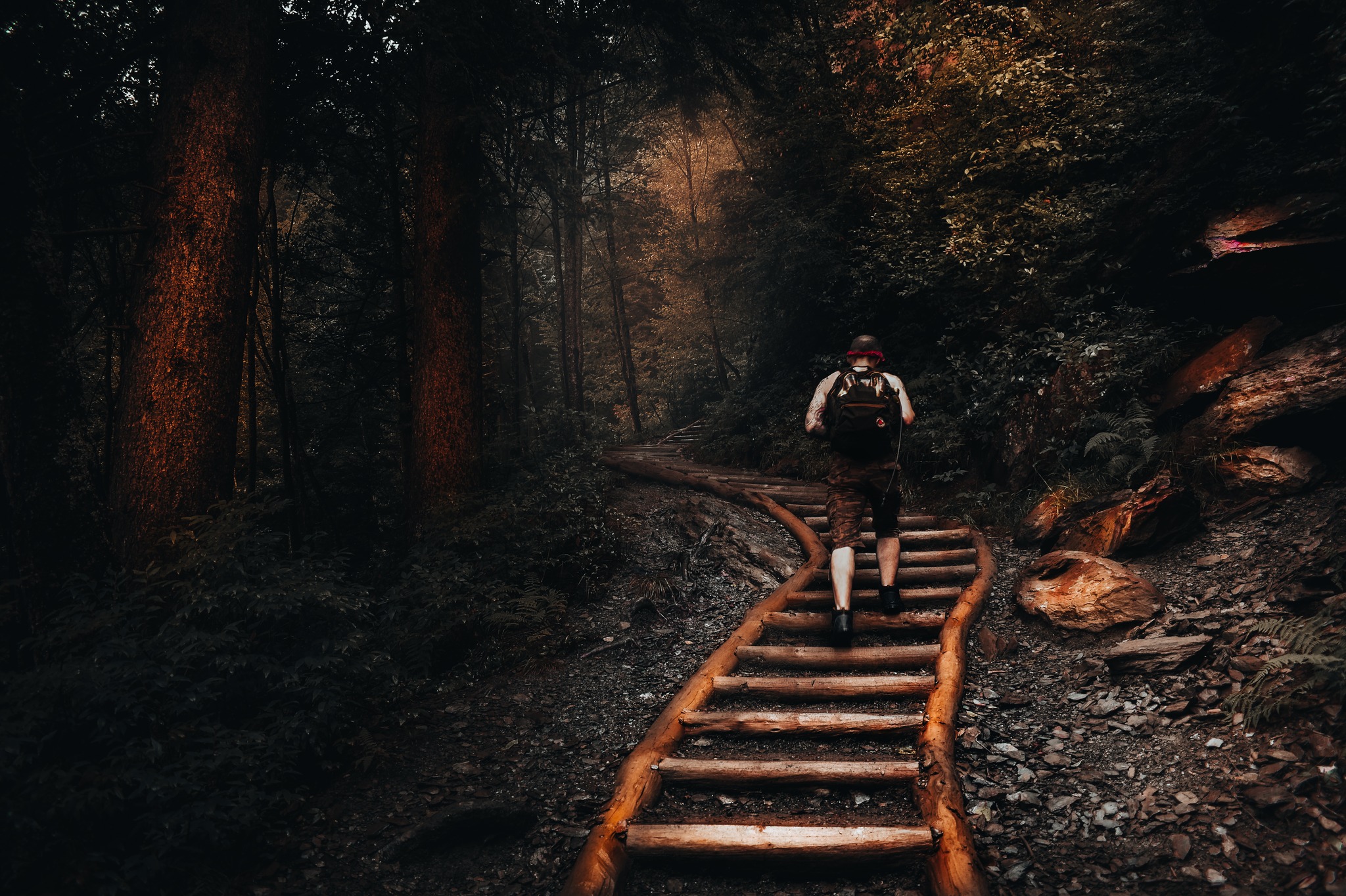 A man climbing a small set of stairs between two stairs.