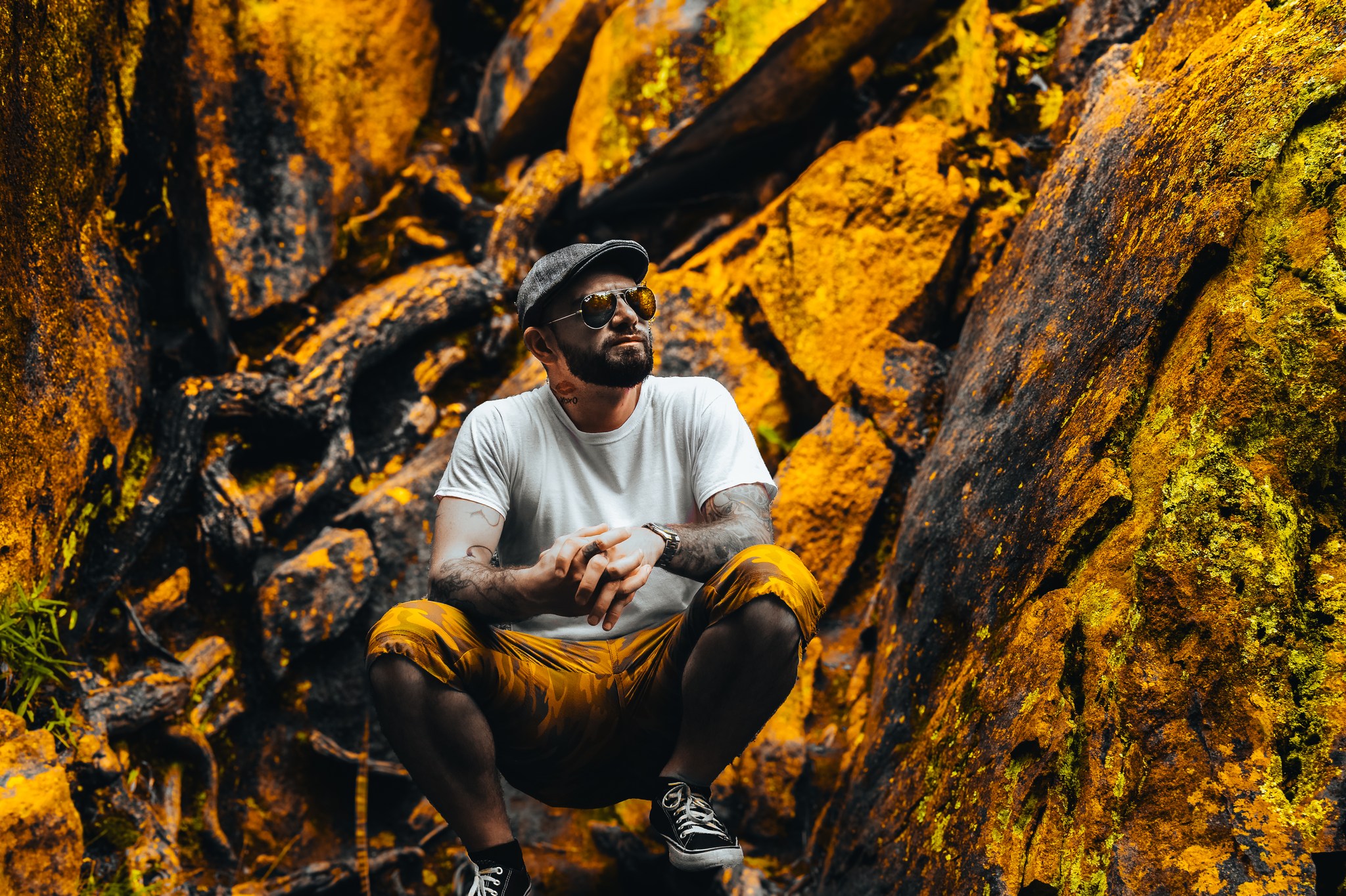 A man standing in front of rocks.