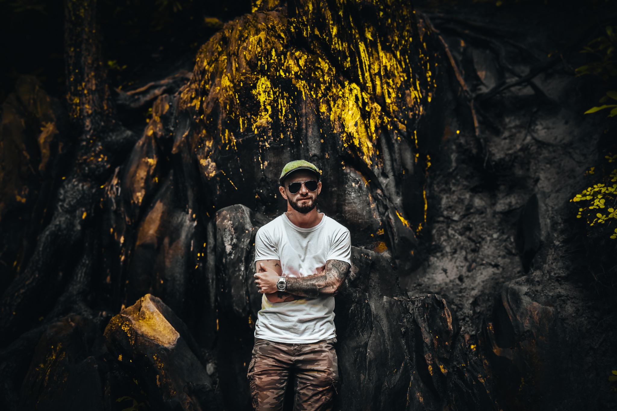 A man standing in front of rocks.